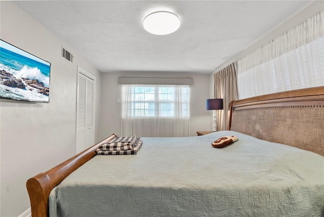 bedroom with visible vents and a closet