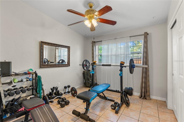 workout area featuring baseboards, a ceiling fan, and tile patterned flooring