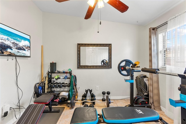 workout area with tile patterned floors, baseboards, and ceiling fan