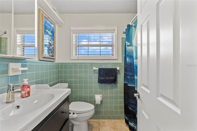 bathroom featuring vanity, a shower with curtain, tile patterned flooring, tile walls, and toilet