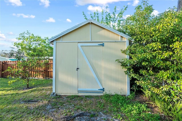 view of shed featuring fence