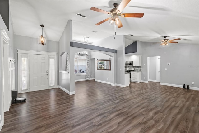 foyer entrance featuring visible vents, arched walkways, dark wood finished floors, and ceiling fan with notable chandelier