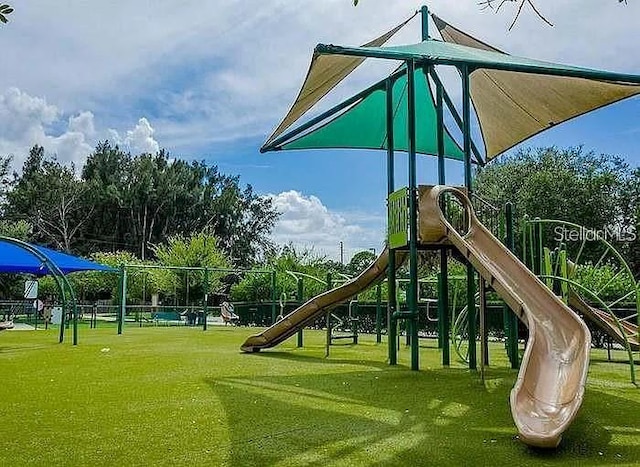 communal playground featuring a lawn