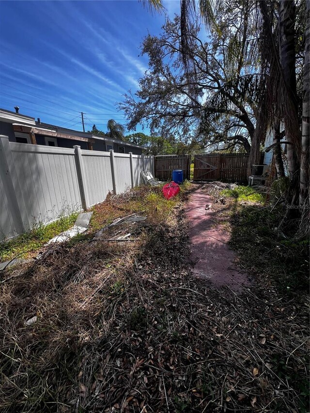 view of yard featuring a gate and fence