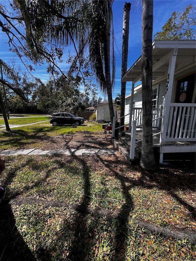 view of yard featuring covered porch