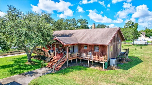 6501 62nd St N, Pinellas Park, FL 33781 - view of front of house with a chimney, a front lawn, stairway, and a deck