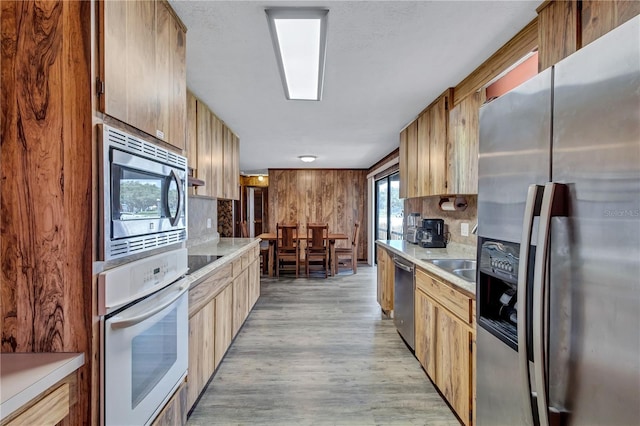6501 62nd St N, Pinellas Park, FL 33781 - kitchen featuring light wood-type flooring, light countertops, decorative backsplash, and stainless steel appliances