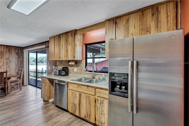 6501 62nd St N, Pinellas Park, FL 33781 - kitchen featuring light countertops, a sink, light wood-style flooring, stainless steel appliances, and decorative backsplash
