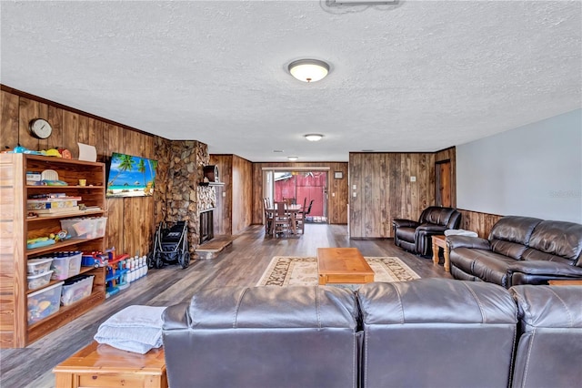 6501 62nd St N, Pinellas Park, FL 33781 - living room featuring a textured ceiling, wood finished floors, and wood walls