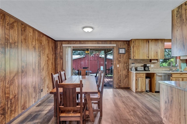 6501 62nd St N, Pinellas Park, FL 33781 - dining room featuring light wood-style flooring, crown molding, wooden walls, and baseboards