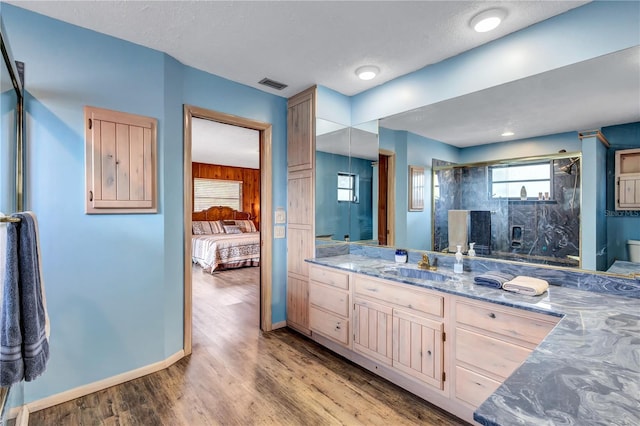 6501 62nd St N, Pinellas Park, FL 33781 - bathroom featuring vanity, a shower stall, wood finished floors, baseboards, and visible vents