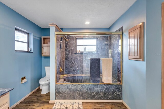 6501 62nd St N, Pinellas Park, FL 33781 - full bathroom with a wealth of natural light, toilet, a tub with marble appearance, and a marble finish shower
