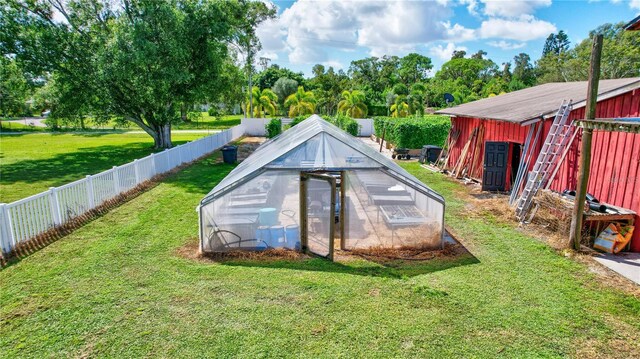 6501 62nd St N, Pinellas Park, FL 33781 - view of pool featuring an outdoor structure, a fenced backyard, a greenhouse, and a yard