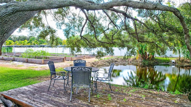 6501 62nd St N, Pinellas Park, FL 33781 - view of patio / terrace featuring a water view, fence, and a garden