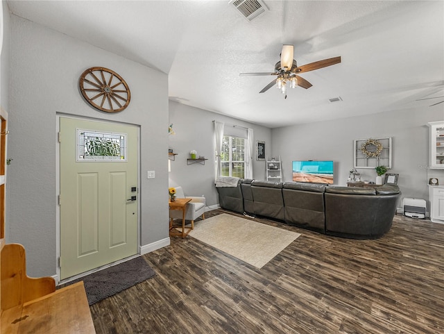 foyer entrance with visible vents, baseboards, dark wood-type flooring, and ceiling fan