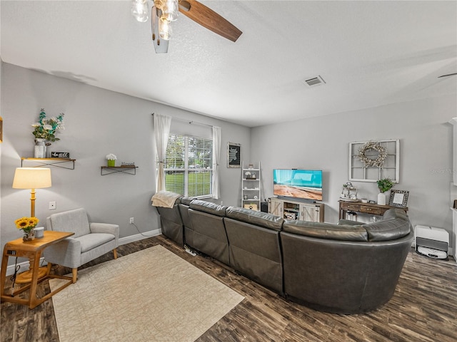 living room with baseboards, wood finished floors, and a ceiling fan