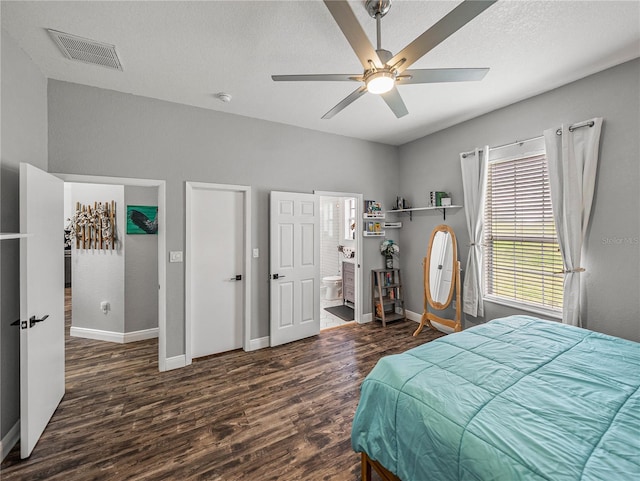 bedroom featuring visible vents, a ceiling fan, a textured ceiling, wood finished floors, and baseboards