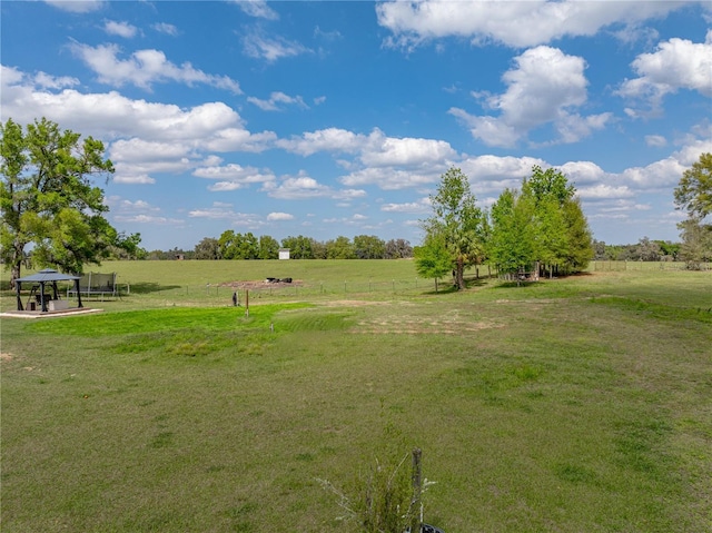 view of home's community with a gazebo, a yard, and a rural view