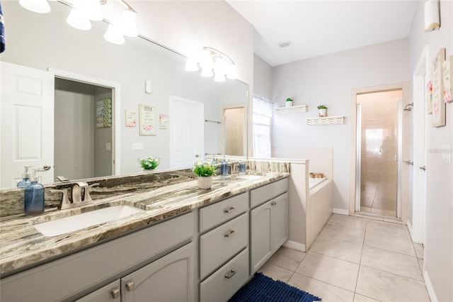 bathroom with tile patterned flooring, a shower stall, a bath, and a sink