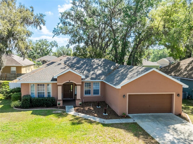 single story home with stucco siding, an attached garage, a front lawn, and a shingled roof