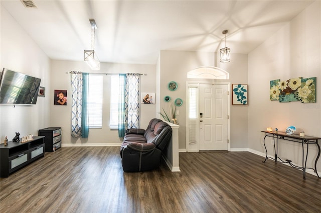 foyer with visible vents, baseboards, and dark wood finished floors