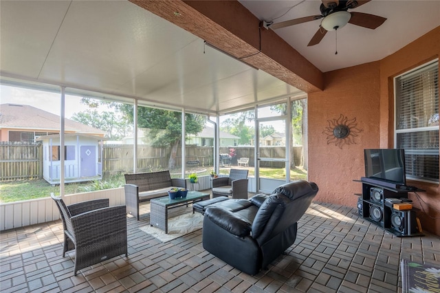 sunroom / solarium with a ceiling fan