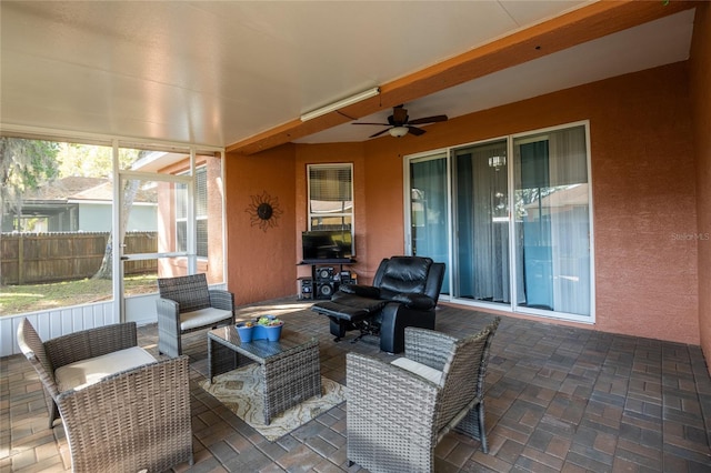 sunroom with ceiling fan