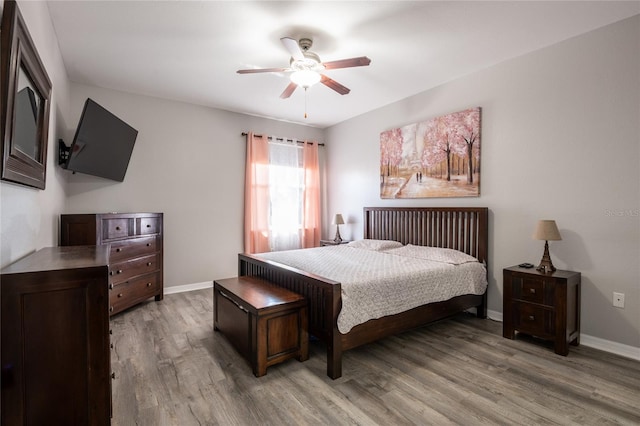 5416 Oxford Manor Cir, Lakeland, FL 33810 - bedroom featuring light wood finished floors, ceiling fan, and baseboards