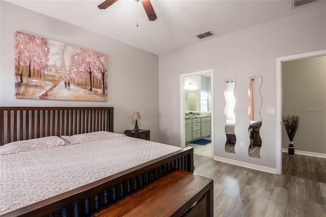 5416 Oxford Manor Cir, Lakeland, FL 33810 - bedroom with visible vents, ensuite bathroom, baseboards, and wood finished floors