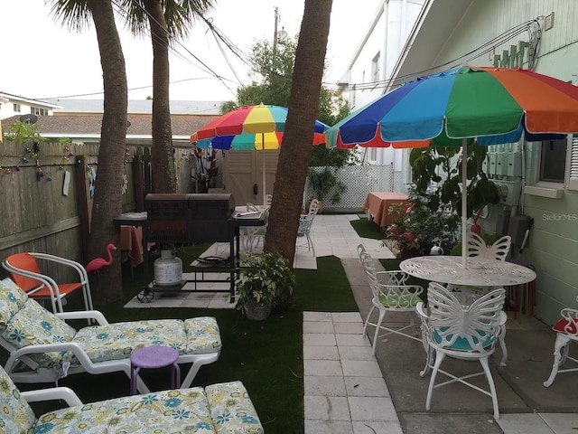 view of patio with outdoor dining area and a fenced backyard