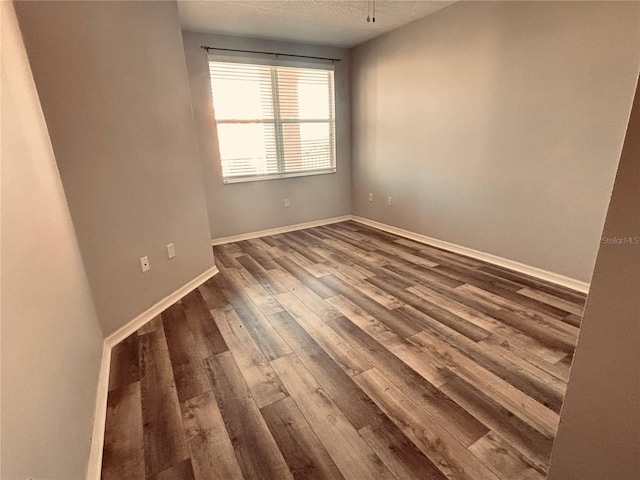 1200 Country Club Dr Unit 3303, Largo, FL 33771 - spare room with wood finished floors, a textured ceiling, and baseboards