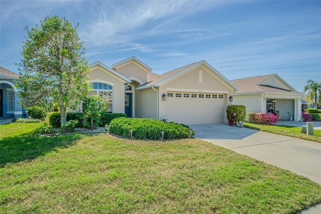 ranch-style house with stucco siding, concrete driveway, a front yard, and a garage