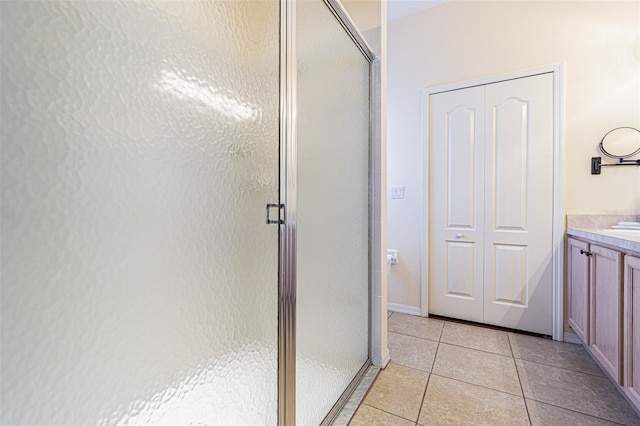 full bathroom with vanity, tile patterned floors, baseboards, and a stall shower