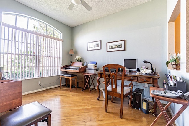 home office featuring baseboards, a textured ceiling, a ceiling fan, and wood finished floors