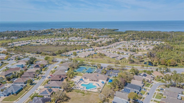 drone / aerial view featuring a water view and a residential view