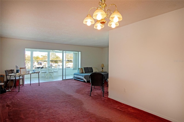 sitting room with a chandelier, carpet flooring, and a textured ceiling