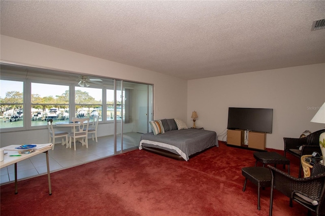 tiled bedroom with a textured ceiling and carpet