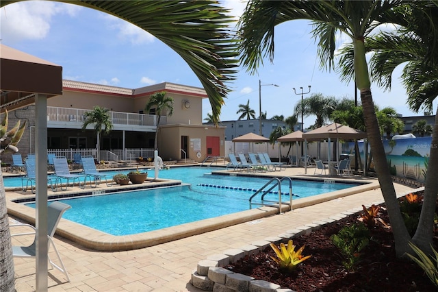 community pool featuring a patio and fence