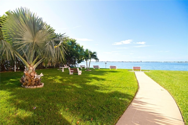 exterior space featuring a lawn and a water view