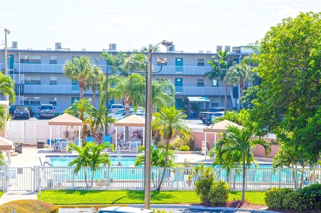 exterior space featuring a swimming pool, a patio, and fence