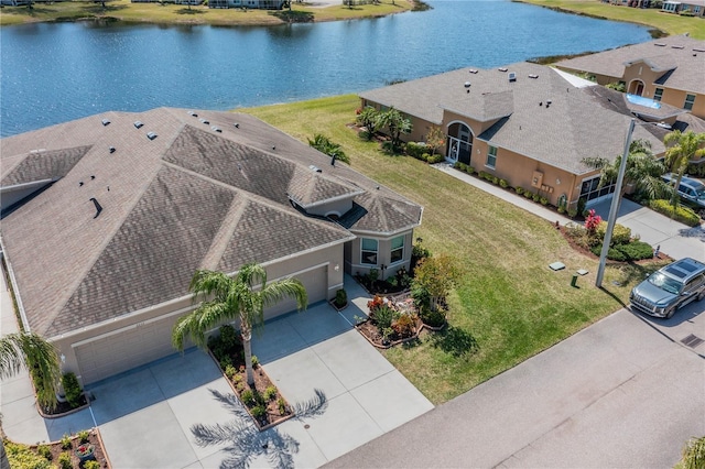 birds eye view of property with a water view