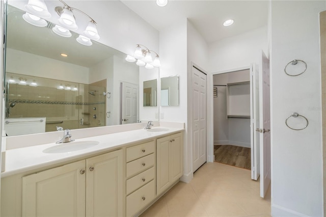 2234 Nottingham Greens Dr Unit 2234, Sun City Center, FL 33573 - bathroom with tile patterned flooring, double vanity, tiled shower, and a sink