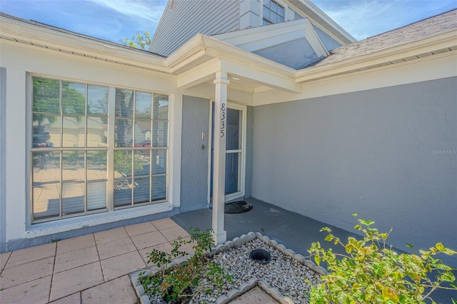 entrance to property featuring stucco siding