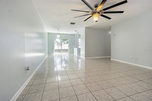 unfurnished room featuring visible vents, a textured ceiling, light tile patterned floors, baseboards, and ceiling fan