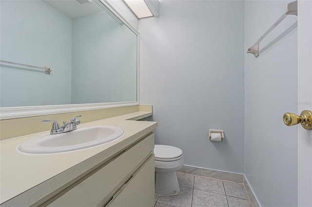 bathroom with baseboards, toilet, and vanity