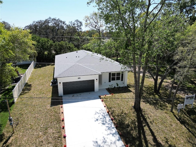 9445 Eldridge Rd, Spring Hill, FL 34608 - ranch-style house with an attached garage, a shingled roof, concrete driveway, and stucco siding