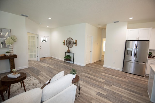 9445 Eldridge Rd, Spring Hill, FL 34608 - living room featuring light wood-style flooring and recessed lighting