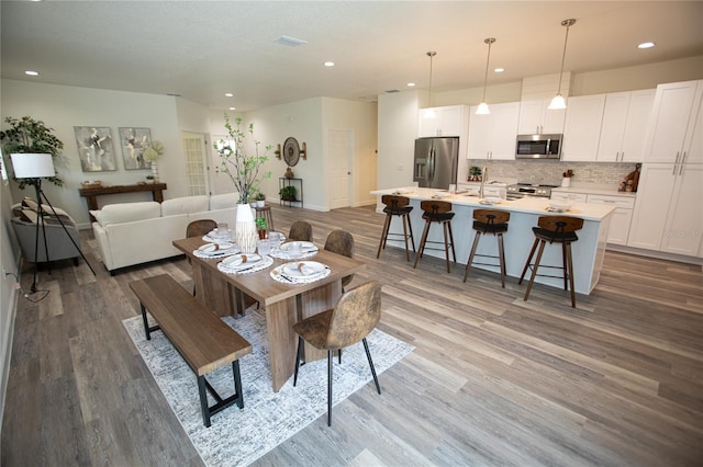 9445 Eldridge Rd, Spring Hill, FL 34608 - dining room with wood finished floors and recessed lighting
