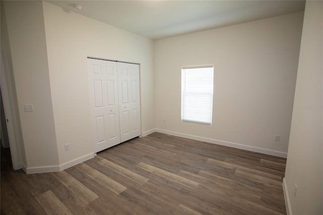 9445 Eldridge Rd, Spring Hill, FL 34608 - unfurnished bedroom with wood finished floors and a closet