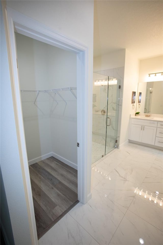9445 Eldridge Rd, Spring Hill, FL 34608 - full bath featuring vanity, marble finish flooring, a marble finish shower, and a walk in closet